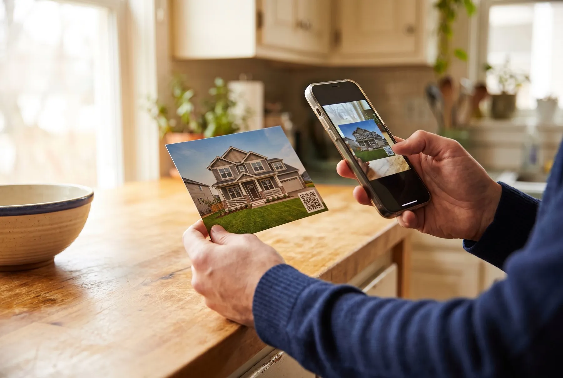 A homeowner scanning the code on a postcard with a phone